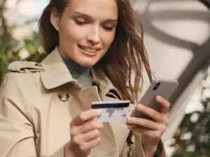 Woman Smiling after adding funds to her debit card