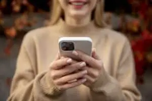 A woman is looking at the phone after receiving an automated incentive. Incentive Automation is transforming gift card delivery.
