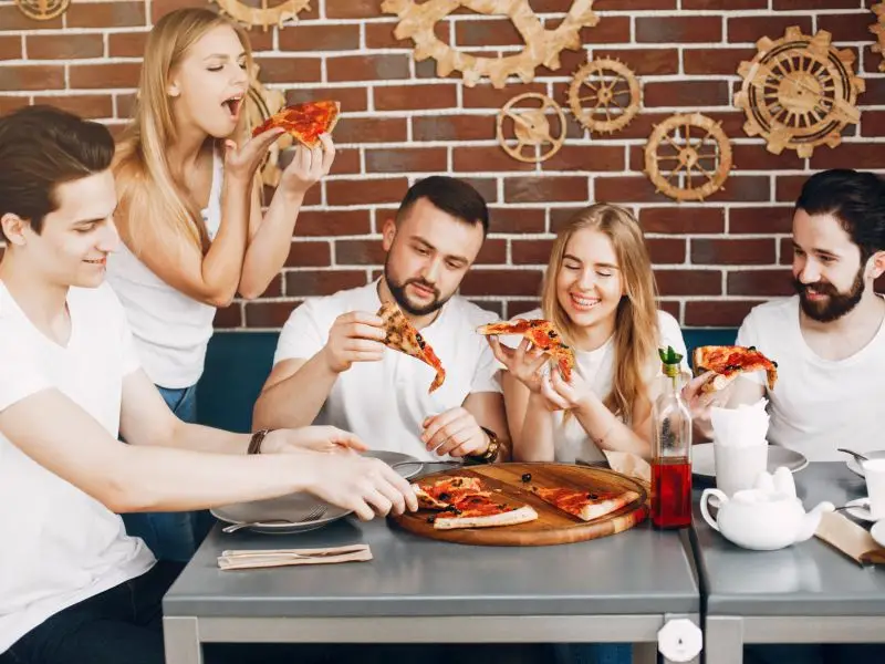 Group of employees enjoying pizza on a company pizza day