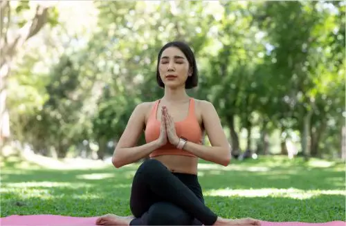 Woman in park enjoying Yoga