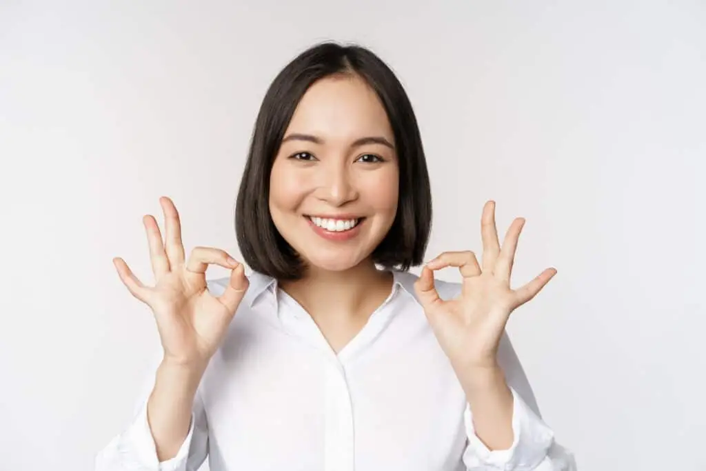 Woman showing two OK signs for National Compliment Day!