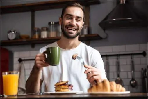 Man enjoying a breakfast of pancakes