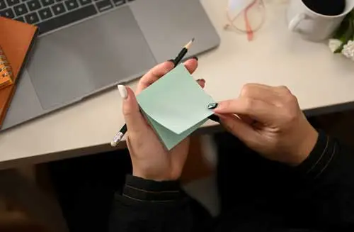 A woman about to make a note on a memo