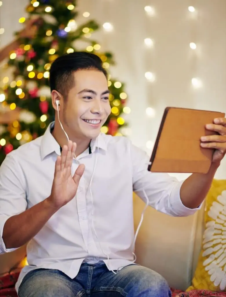 Employee talking with his boss on an iPad after receiving a holiday gift