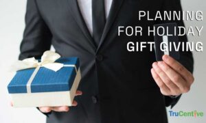 Man holding a gift card and present for holiday employee gift giving