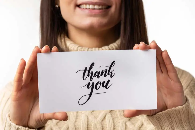 Woman holding a thank you card