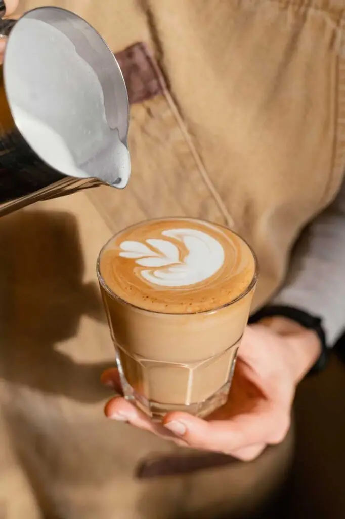 Barista pouring coffee drink
