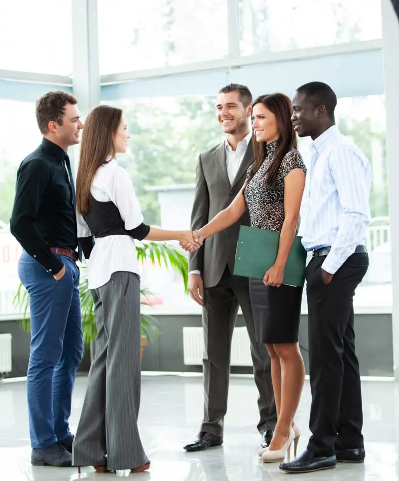 Image of young business executives greeting